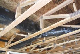 Open web floor trusses during rough framing.