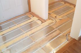 An example of an above floor tube & plate radiant panel during construction.