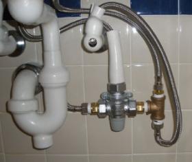 Picture of thermostatic mixing valves installed beneath a lavatory